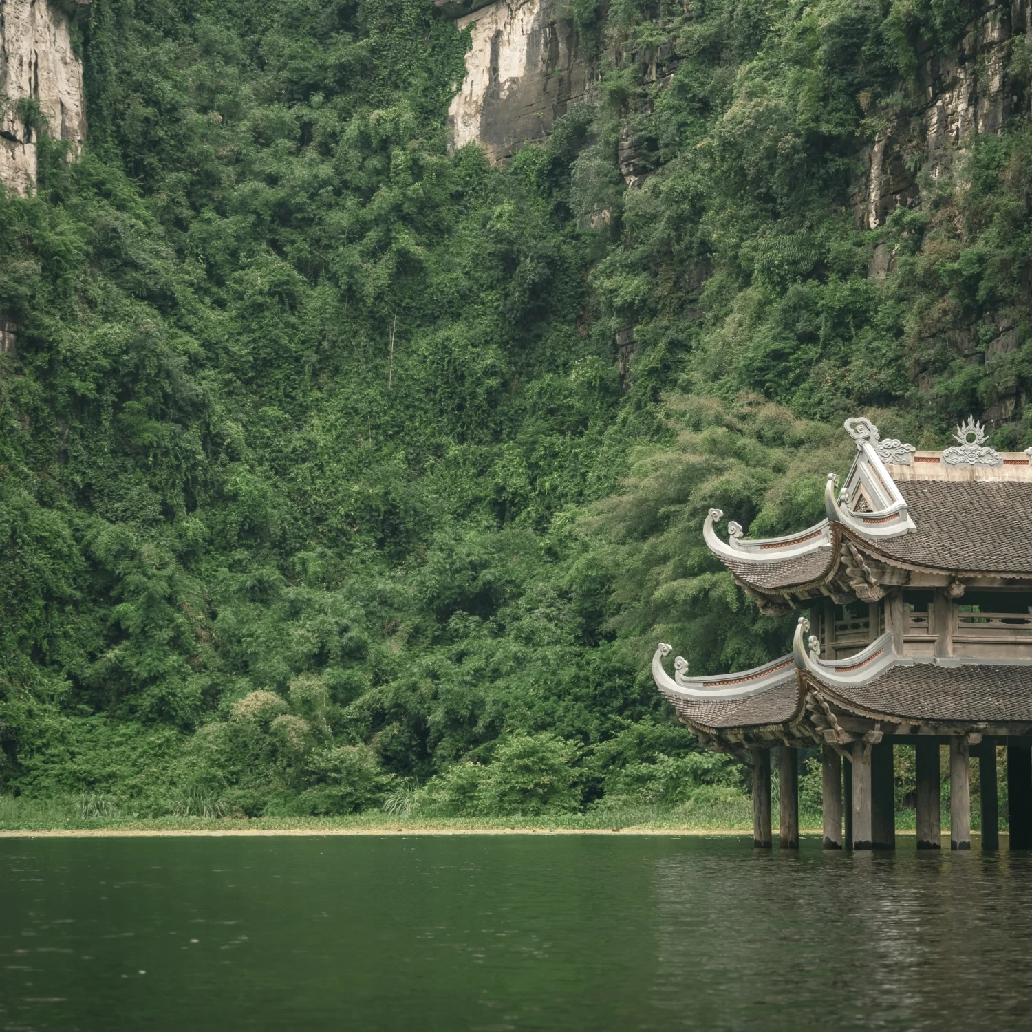 Still water between limestone formations in Ninh Bình
