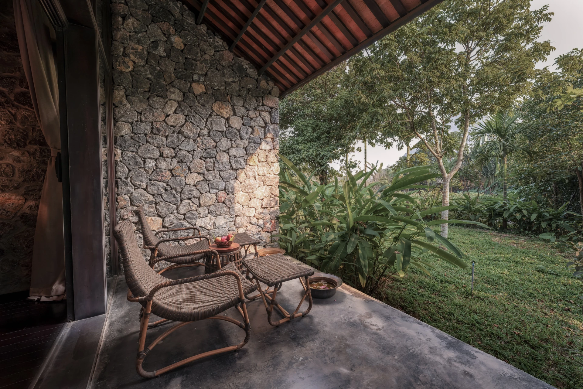 A shaded terrace looking towards a garden